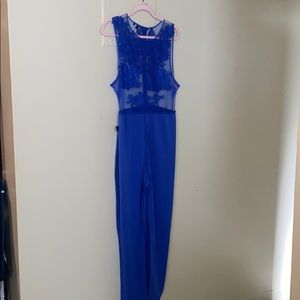 Sheer blue jumpsuit with blue embroidered patches
